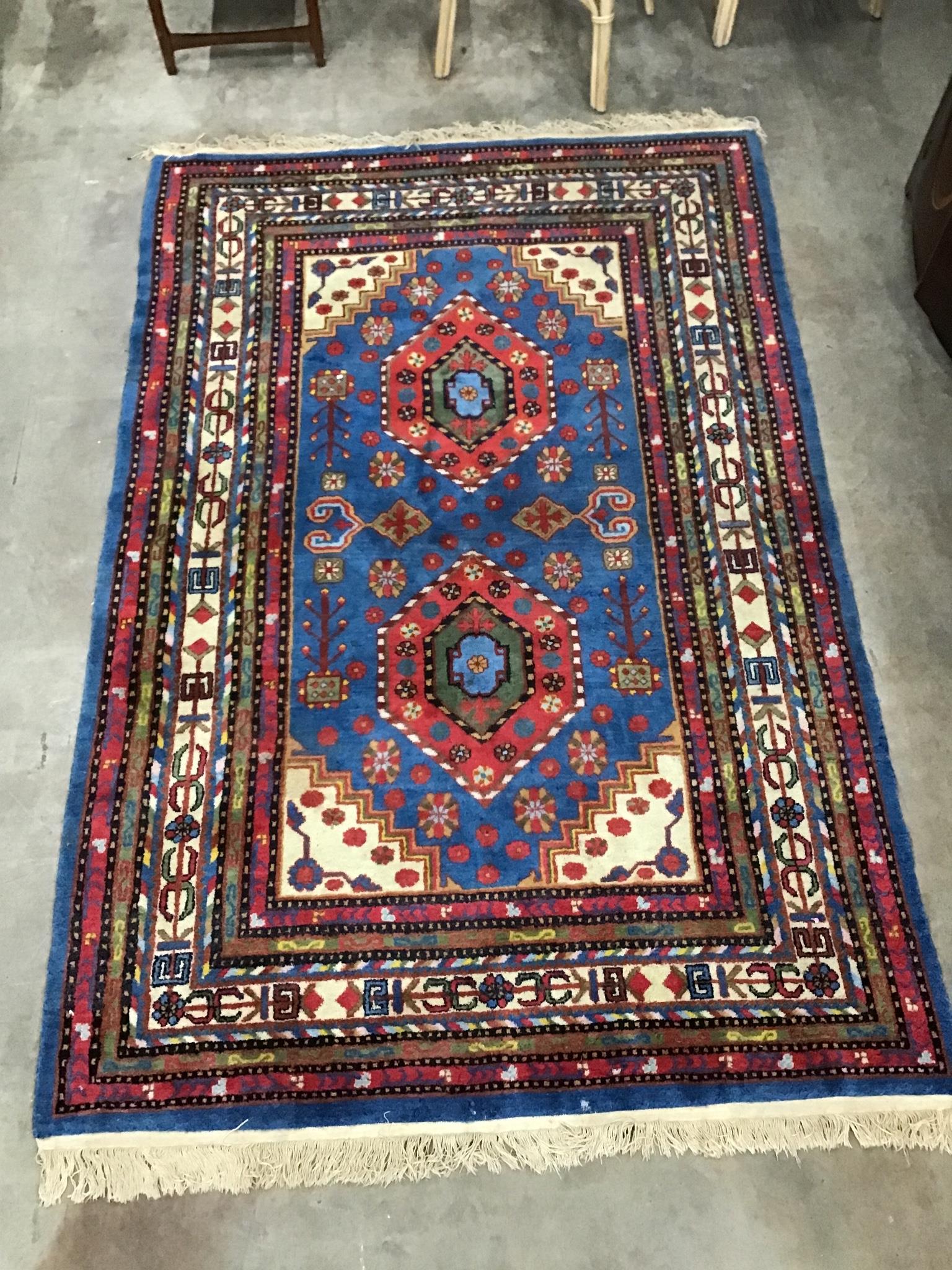 A Caucasian blue ground geometric rug, 240 x 160cm
